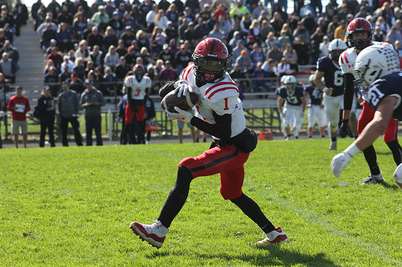 Huntley senior Bryce Walker eyes more yards against Cary-Grove in the Red Raiders' 29-28 win over the Trojans Oct. 7.