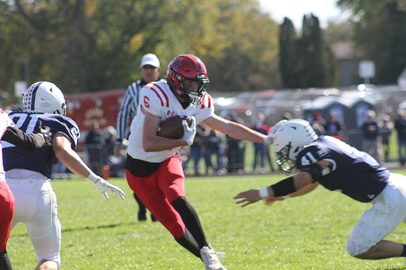 Huntley senior Jake Witt gets past a Cary-Grove defender. The Red Raiders edged the Trojans, 29-28, Oct. 7. Huntley hosts Niles West in first round of the IHSA Class 8A Playoffs at 7 p.m., Oct. 27.