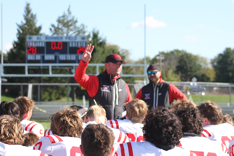 The scoreboard at Al Bohrer Field at Cary-Grove showed the story of Huntley's dramatic 29-28 victory over the host Trojans Oct. 7. Red Raiders head coach Mike Naymola congratulates the players.