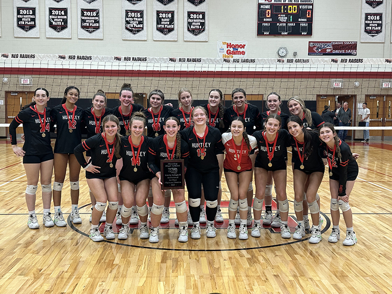 The Red Raiders girls volleyball team celebrates winning the Huntley Invite championship Oct. 7.