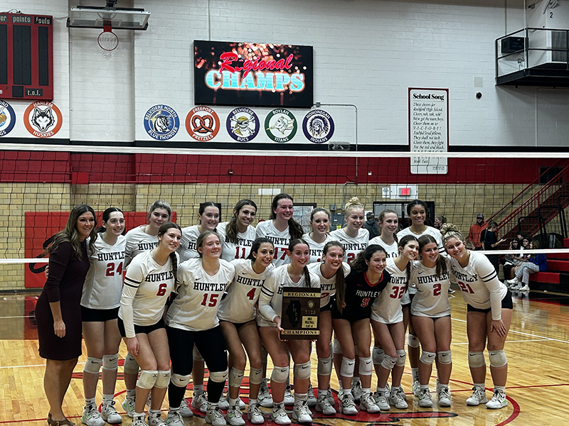 Huntley's volleyball team celebrates winning the Class 4A Rockford East Regional Oct. 26. The Red Raiders beat Dundee-Crown, 25-12, 25-13.