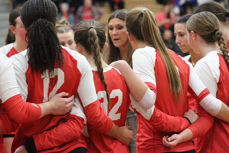 Huntley volleyball coach Karen Naymola talks to the team during a timeout against Warren. Warren defeated the Red Raiders, 2-1, in the Huntley Class 3A Sectional semifinal Oct. 30.