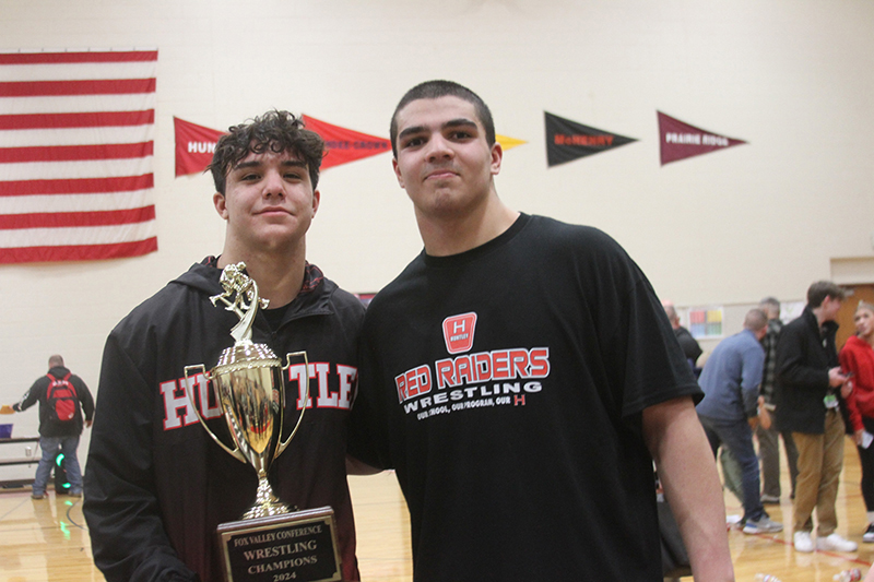 Huntley seniors Alex Niepentak, left and Marcos Mihalouplos show the Fox Valley Conference wrestling trophy earned by the Red Raiders.