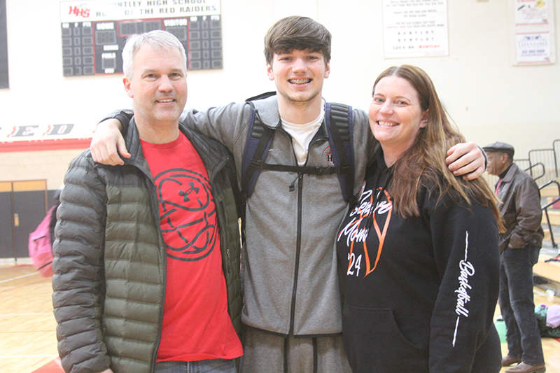 Huntley senior Ryan Sweeney shares a senior night moment with his parents, James and Jessica, after a game against Crystal Lake South Feb. 6.