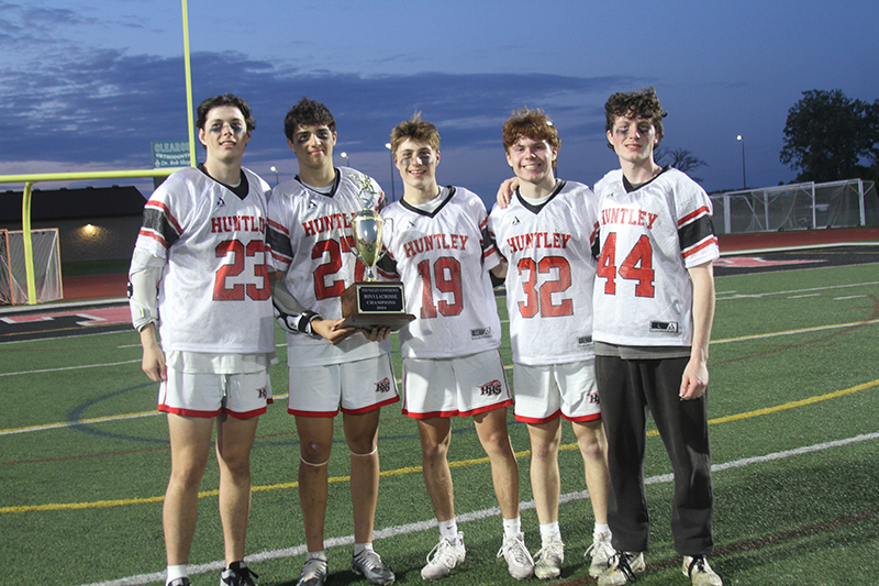 Huntley boys lacrosse players show the Fox Valley Conference trophy after the Red Raiders beat Cary-Grove 17-7 May 10. From left: Cole Copersmet, Nico Andrews, Alex Cunningham, Trace Tedesco and Colin McDougall.