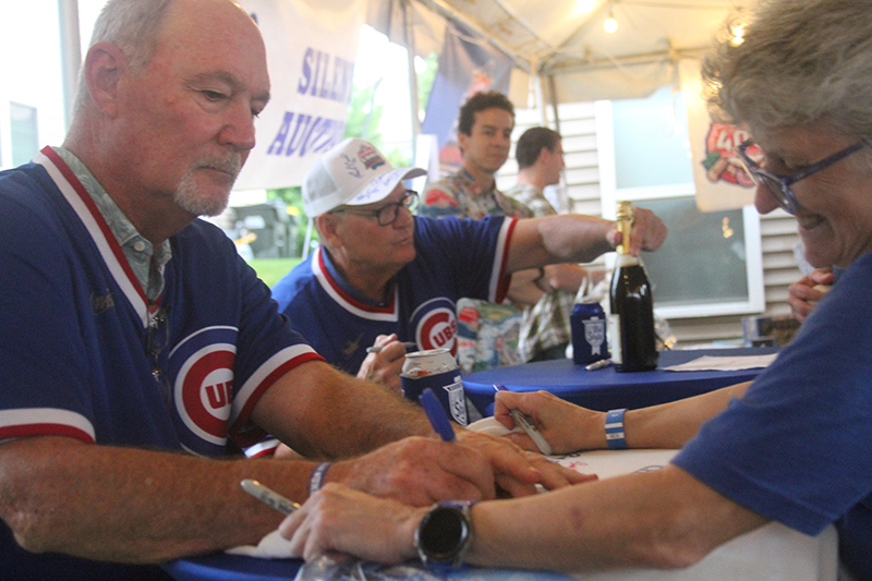 Chicago Cubs fan Patti Munch has an item autographed by ex-Cub pitcher Rich Bordi. Bordi's teammate Steve Trout is also shown. Club 400 in Lake in the Hills hosted a 1984 Cubs 40th reunion.