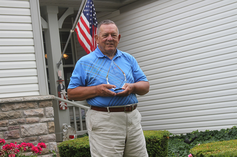 Jim Meyers of Sun City, a retired high school athletic director, shows his Hall of Fame Plaque he received from the Illinois Athletic Director's Association.