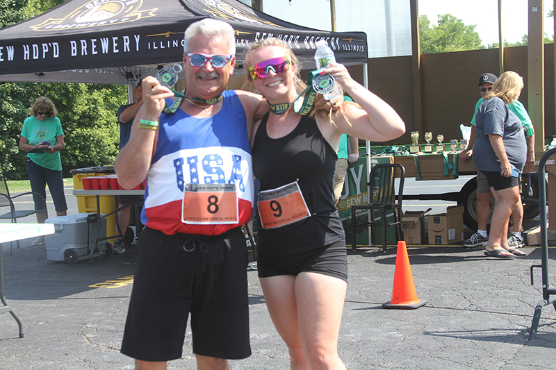 Savannah Henn and her dad Tom celebrste after finishing the Beer Mile run event at Sew Hop'd Brewery and Taproom in Huntley July 27.