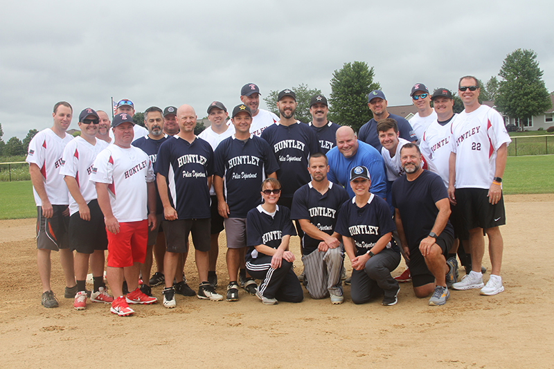 Huntley Police Department and Huntley Fire Protection District softball players pose before the annual softball game at Sun City's Veterans Memorial Park Aug. 6.