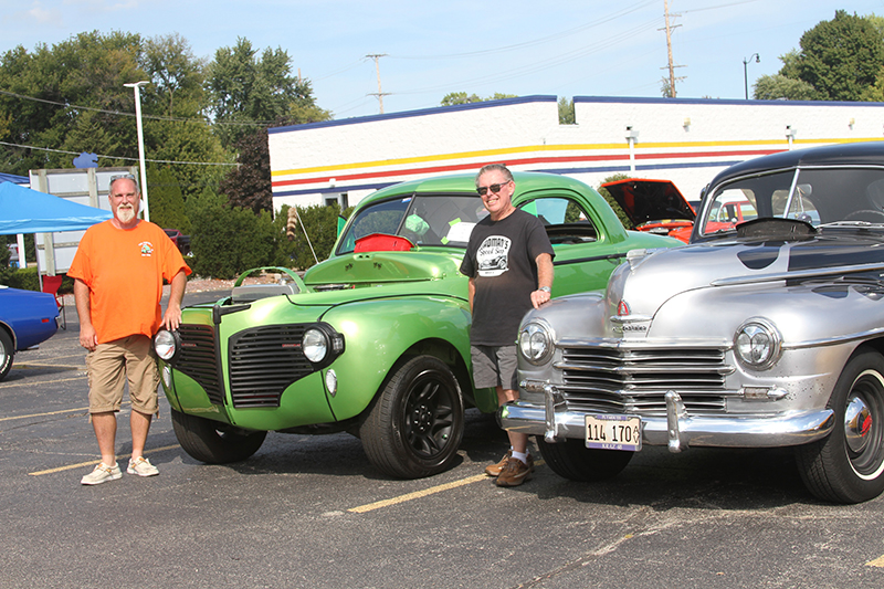 Huntley residents Mike Wadman, left and his dad Tim, show their cars on display at the Freemasons' Car Show Sept. 14.