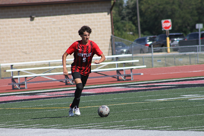 Noah Gomez starts a play for Huntley's soccer team against Hononegah.