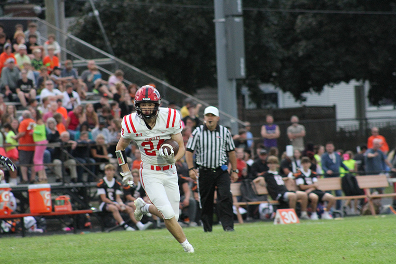 Huntley junior Gavin Havens carries the ball against Crystal Lake Central. The Red Raiders prevaied 35-7 in the season opener.