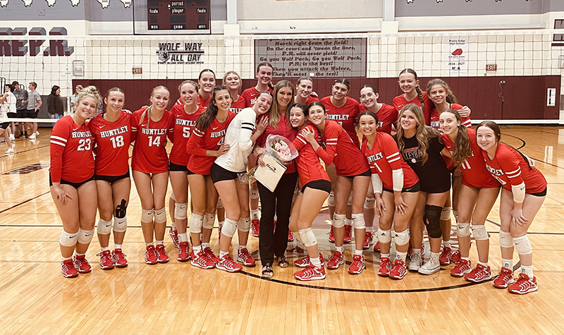 Huntley girls volleyball team members celebrate head coach Karen Naymola's 500th coaching win Sept. 5 at Prairie Ridge.