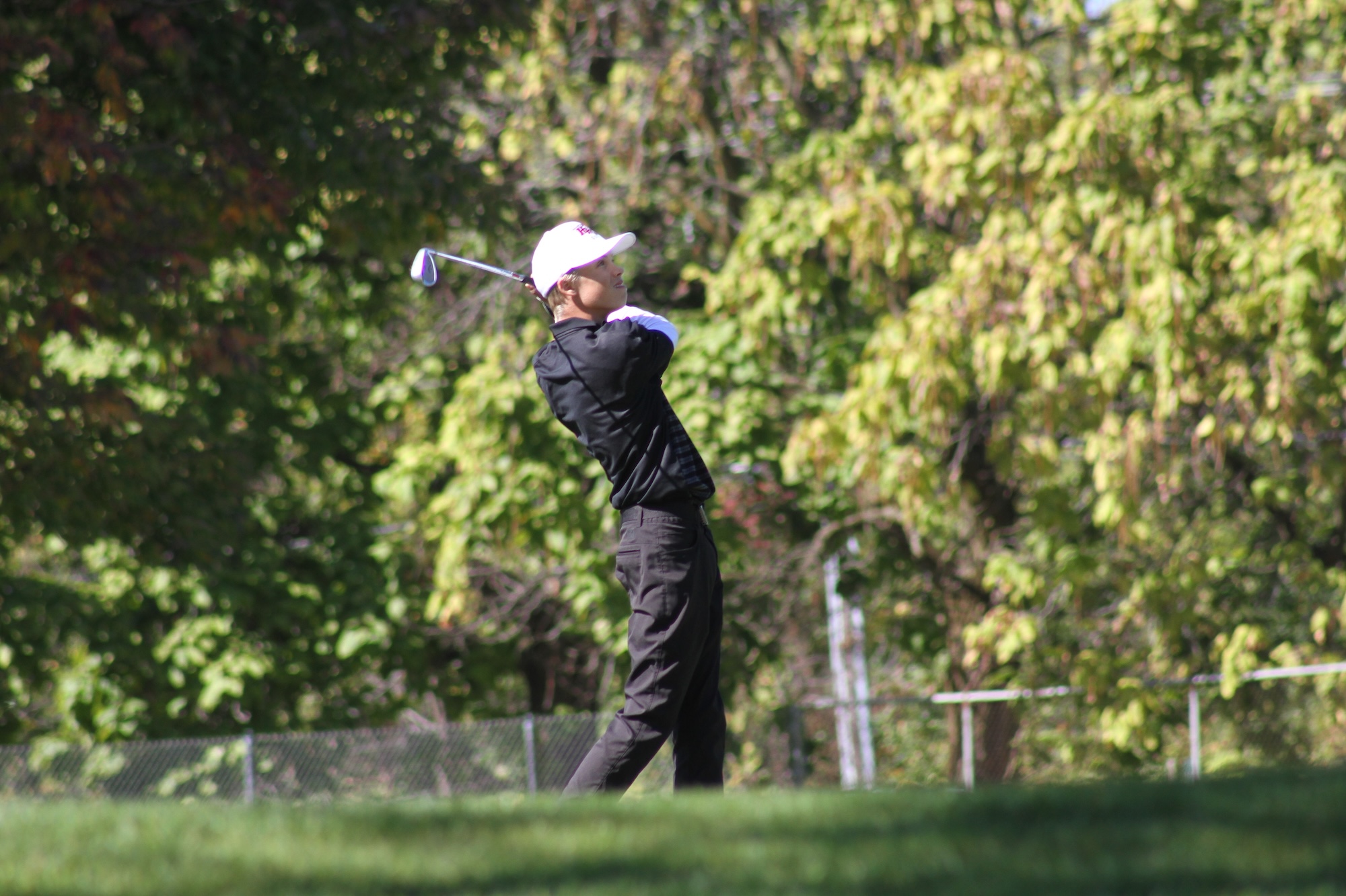 Huntley sophomore Carson Elder makes a shot at the 18th hole of the IHSA Class 3A boys golf regional.