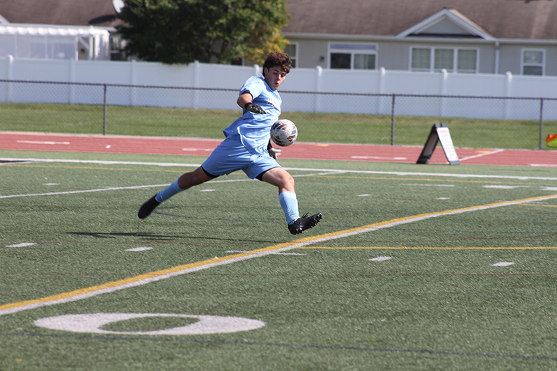 Huntley goalie Jeremiah Reynolds clears the ball after a save against Geneva Oct. 5.