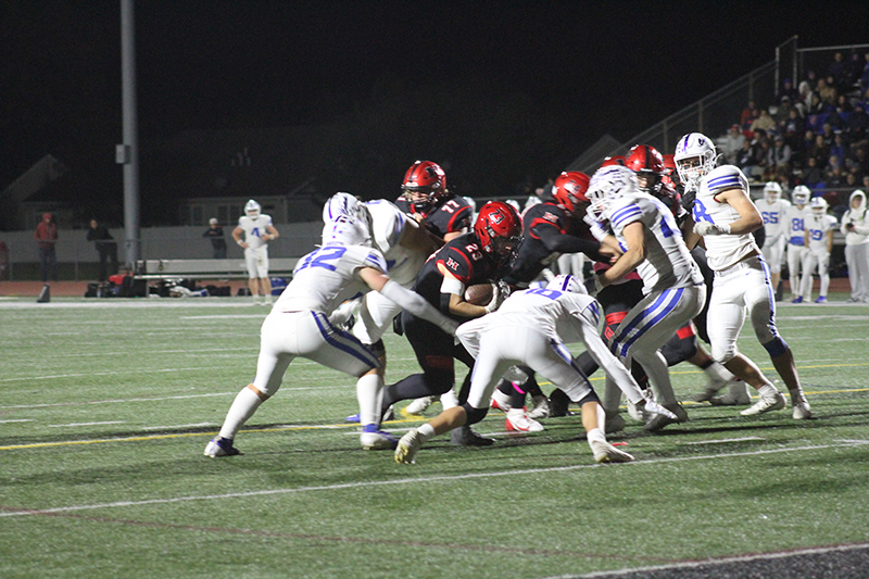 Huntley senior Zach Rysavy encourages the fans to shout support before a goal-line stand against Burlington Central.