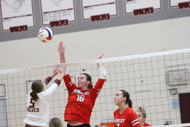 Huntley senior Georgia Watson goes for a kill against Prairie Ridge earlier this season. Teammate Jocelyn Erling looks on.