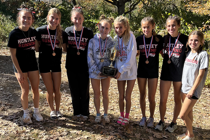 The Huntley girls cross country team celebrates its Fox Valley Conference team championship. From left: Abbie Williams, Aspen Maldonado, Morgan Sauber, Isabella Ciesla, Haley Rahman, Mackenzie Billard, and Mckenna Corso.