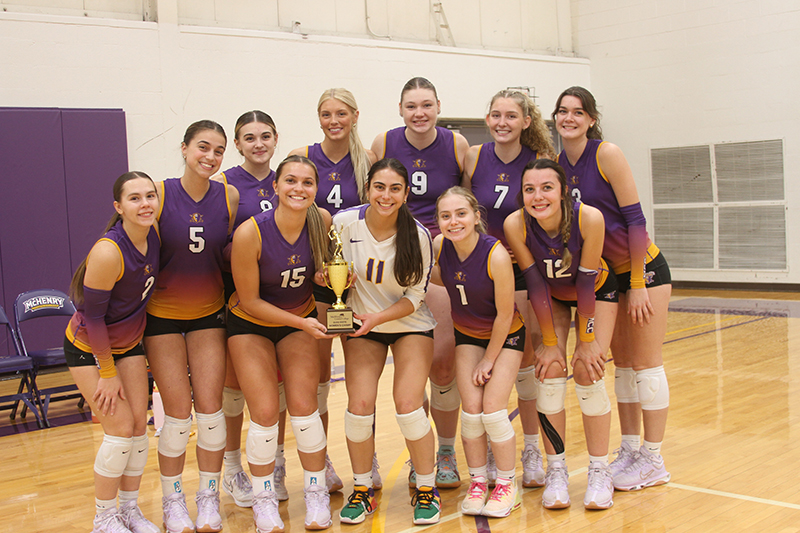 McHenry County College women's volleyball team celebrates recently after earning the trophy for winning the Skyway Conference championship.