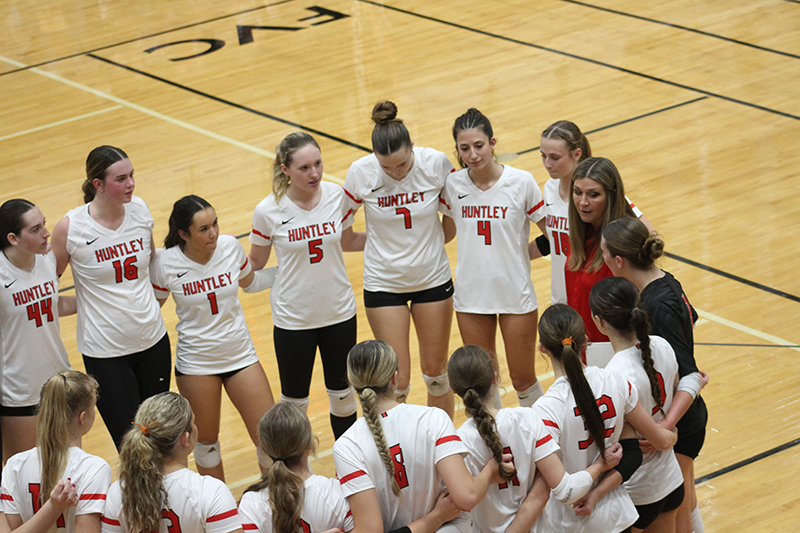 Huntley's volleyball team huddles during a timeout against Mundelein at the Class 4A McHenry sectional semifinal match.