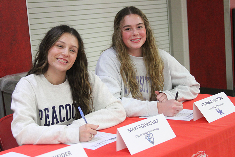 Huntley High School volleyball standouts Mari Rodriquez, left and Georgia Watson, sign their letters of intent to play collegiate volleyball.