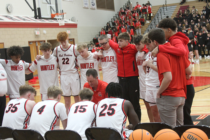 Huntley boys basketball coach Collin Kalamatas calls a play during a timeout against Hampshire. The Red Raiders prevailed 60-53.