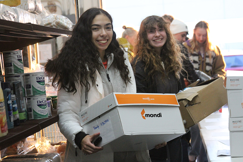 Huntley High School National Honor Society members Vanessa Roman, left and Jersey Caserno help with a box of donated items at Grafton Food Pantry.