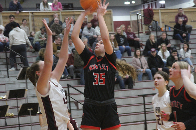 Huntley senior Paula Strzelecki goes up for two points in a game against Prairie Ridge. Anna Campanelli looks on. Huntley reached 23-0 record on the season wirh a 49-34 win at Cary-Grove.