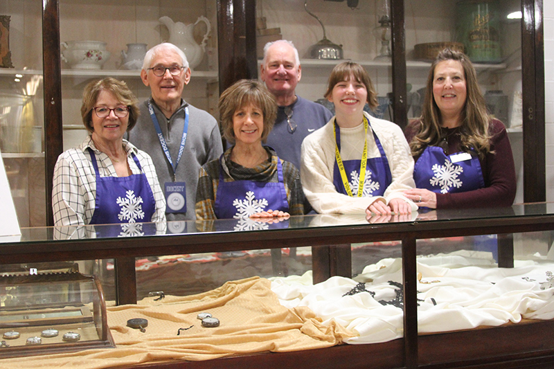 McHenry County Historical Society Museum volunteers show an exhibit at the museum Jan. 25. Front row from left: Deb Julison, Laurie Cisneros, Abbey Davis and MCHS Museum Executive Director Jolie Diepenhorst. Back row: George Kolak and Jim Johnson.