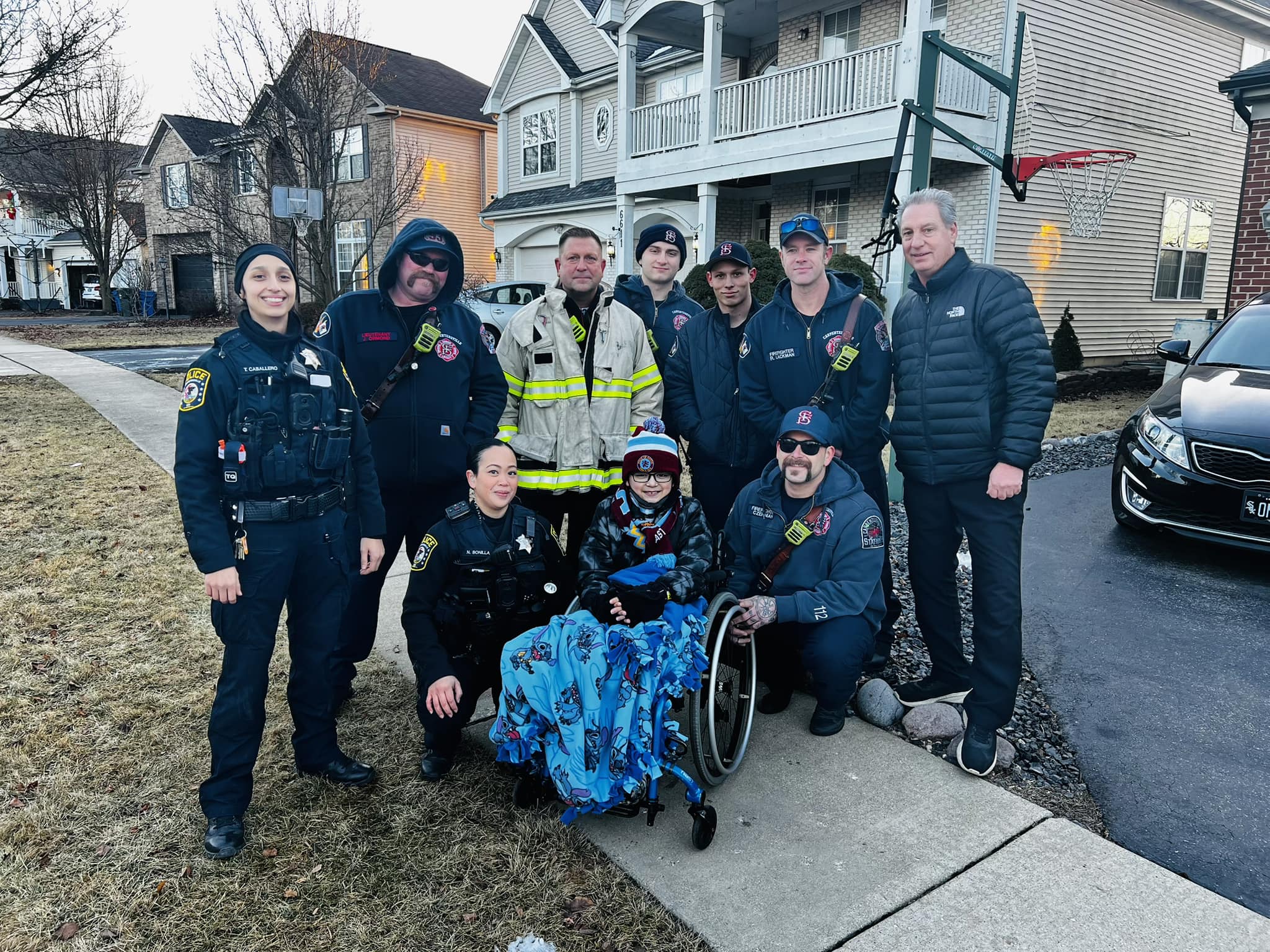 Leo Carmona (Center) was welcomed home by members of the Village of Carpentersville Public Safety team and Village President John Skillman on Jan. 29