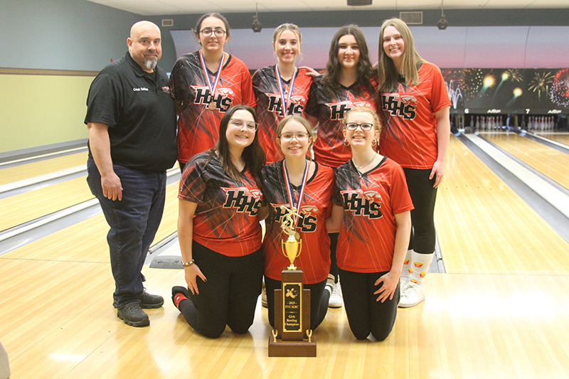 Huntley's girls bowling team celebrates winning the Fox Valley-Kishwaukee River Conference chsmpionship Jan. 31. Front row from left: Kaelyn Keegan, Erica DeBello and Mackenzie Miller. Back row from left: coach Eric DeBello, Prianca Waters, Ashlyn Tenglin, Katie Scaletta and Jana Boudreau.