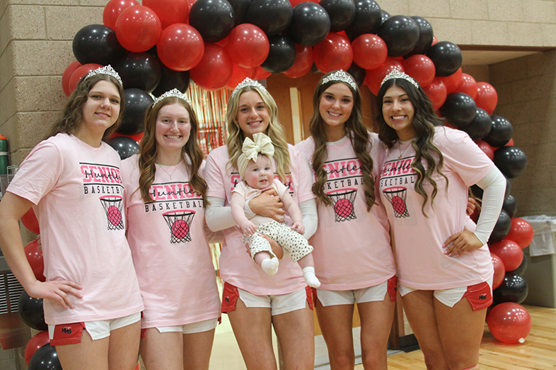 Huntley girls basketball seniors enjoy a pre-game moment with Poppy Green, daughter of assistant coach Sam Green. From left: Paula Strzelecki, Isabella Boskey, Anna Campanelli (holding Poppy), Ava McFadden and Madison Diaz.