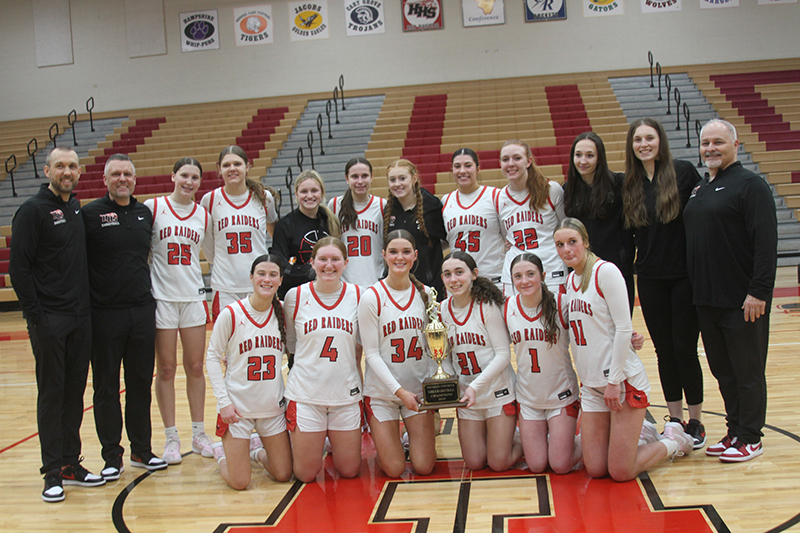 Huntley girls basketball players and coaches show off the Red Raiders' Fox Valley Conference champions trophy. First row from left: Aubrina Adamik, Isabella Boskey, Ava McFadden, Luca Garlin, Lana Hobday and Anna Campanelli. Second row from left: assistant coach Clay Henricksen, head coach Steve Raethz, Evelyn Freundt, Paula Strzelecki, Cece Romano, Alyssa Borzych, Avery Suess, Madison Diaz, Kenzi Oates, Gwen Campbell, assistant coach Sam Green and assistant coach Nick Andrea.