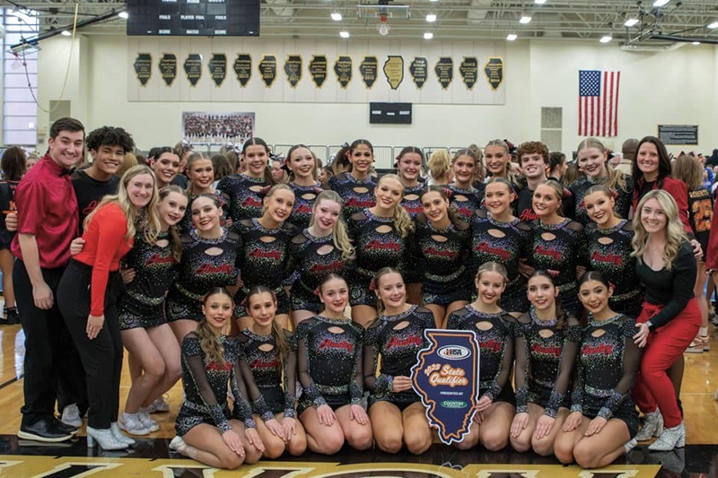 Huntley High School varsity cheerleaders and coaches celebrate qualifying for the IHSA State Competitive Cheerleading meet. They concluded in seventh place at state.