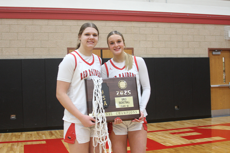 Paula Strzelecki, left snd Anna Campanelli show the Red Raiders' plaque and net won after the 63-50 victory over Libertyville Feb. 27 for the Huntley Class 4A Sectional championship.